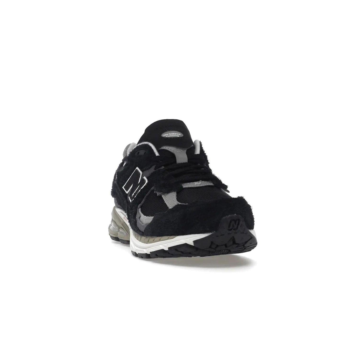New Balance 2002R Protection Pack Black Grey - Image 8 - Only at www.BallersClubKickz.com - Look stylish in the New Balance 2002R Protection Pack Black Grey. Uppers constructed from premium materials like mesh and synthetic overlays. Iconic "N" emblem appears in white and black. ABZORB midsole for shock absorption and responsiveness. Black outsole for grip and traction. Lacing system offers customized fit and cushioned tongue and collar offer comfort and stability. Step up your style with this must-have