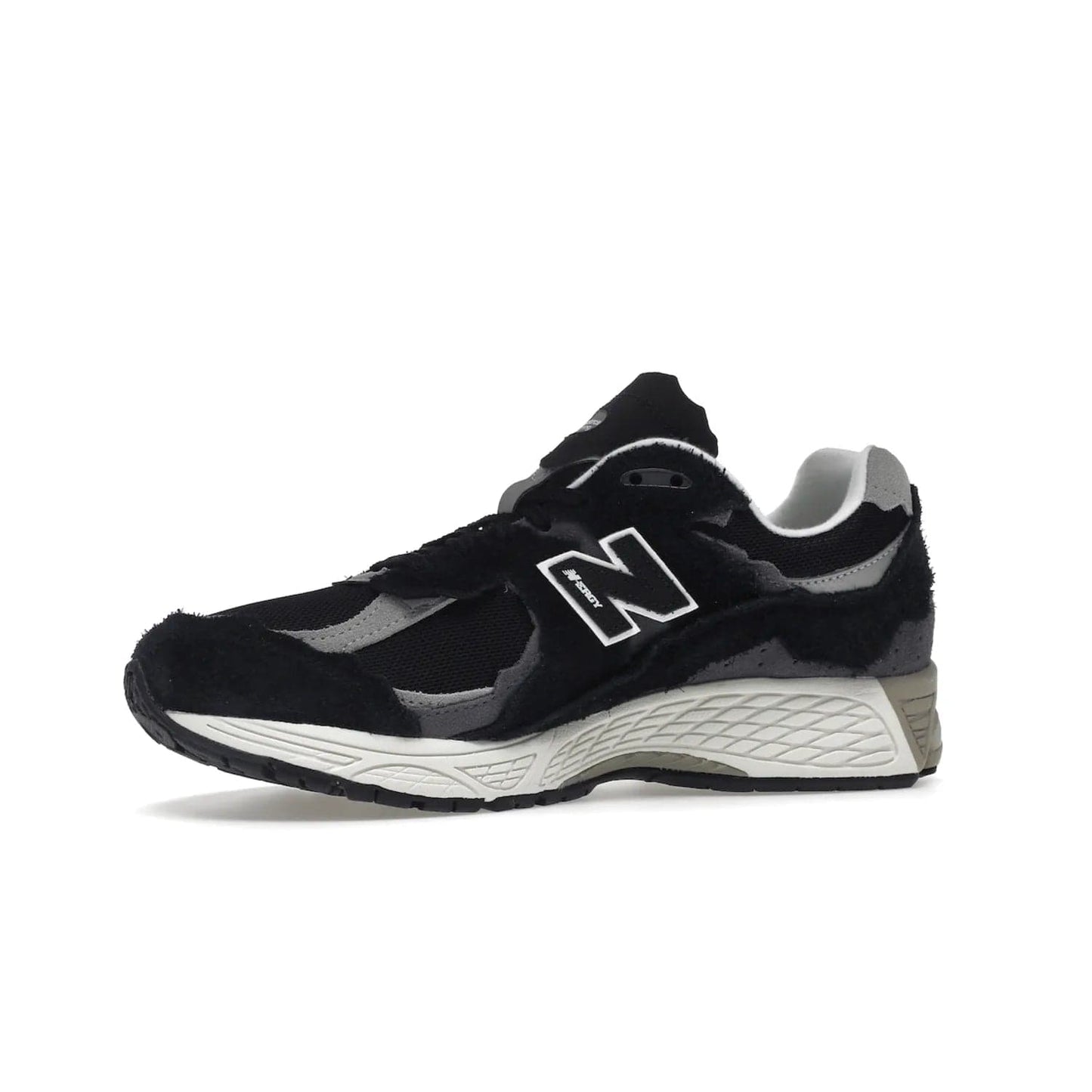 New Balance 2002R Protection Pack Black Grey - Image 17 - Only at www.BallersClubKickz.com - Look stylish in the New Balance 2002R Protection Pack Black Grey. Uppers constructed from premium materials like mesh and synthetic overlays. Iconic "N" emblem appears in white and black. ABZORB midsole for shock absorption and responsiveness. Black outsole for grip and traction. Lacing system offers customized fit and cushioned tongue and collar offer comfort and stability. Step up your style with this must-hav