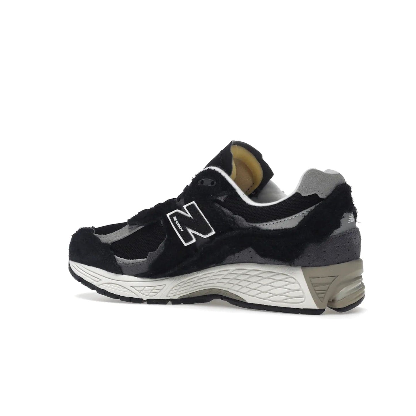New Balance 2002R Protection Pack Black Grey - Image 22 - Only at www.BallersClubKickz.com - Look stylish in the New Balance 2002R Protection Pack Black Grey. Uppers constructed from premium materials like mesh and synthetic overlays. Iconic "N" emblem appears in white and black. ABZORB midsole for shock absorption and responsiveness. Black outsole for grip and traction. Lacing system offers customized fit and cushioned tongue and collar offer comfort and stability. Step up your style with this must-hav