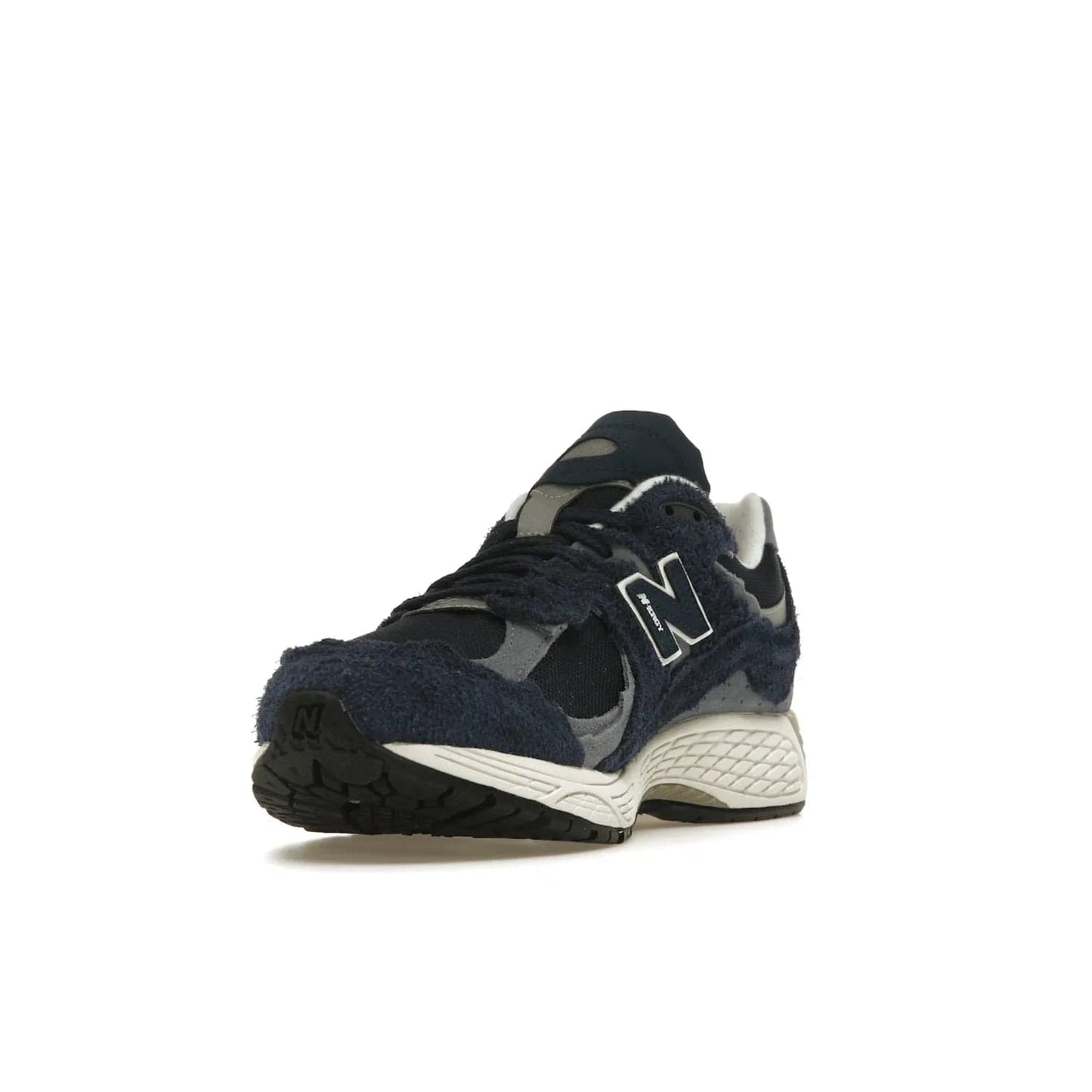 New Balance 2002R Protection Pack Navy Grey - Image 13 - Only at www.BallersClubKickz.com - Get the New Balance 2002R Protection Pack Navy Grey for a statement look. Crafted by Yue Wu, this sneaker features a mesh base, navy suede overlays, and a white and earth midsole. Released Feb 14, 2023.