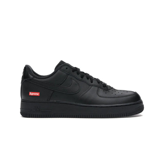 Nike Air Force 1 Low Supreme Black - Image 1 - Only at www.BallersClubKickz.com - Iconic style meets classic black design in the Nike Air Force 1 Low Supreme Black. Featuring a luxe leather upper and red Supreme Box Logo at the heel, these sneakers released in March 2020, and now available.