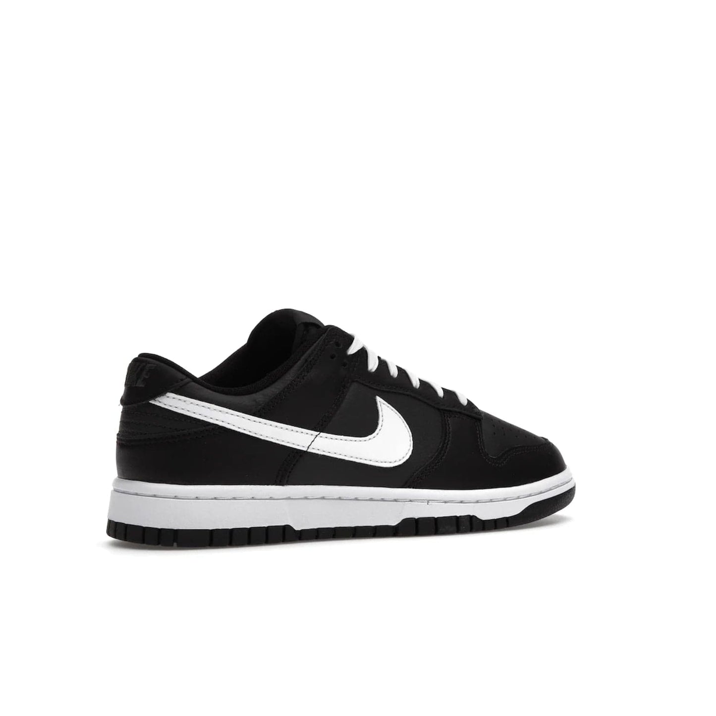 Nike Dunk Low Black White (2022) - Image 34 - Only at www.BallersClubKickz.com - A classic Nike Dunk Low in black and white. Its tumbled leather upper features leather overlays and white Nike Swooshes. The design also includes a woven tongue label and an EVA foam sole for cushioning and support. An effortlessly stylish and timeless look. The Nike Dunk Low Black White (2022) released in May. Step out in style.
