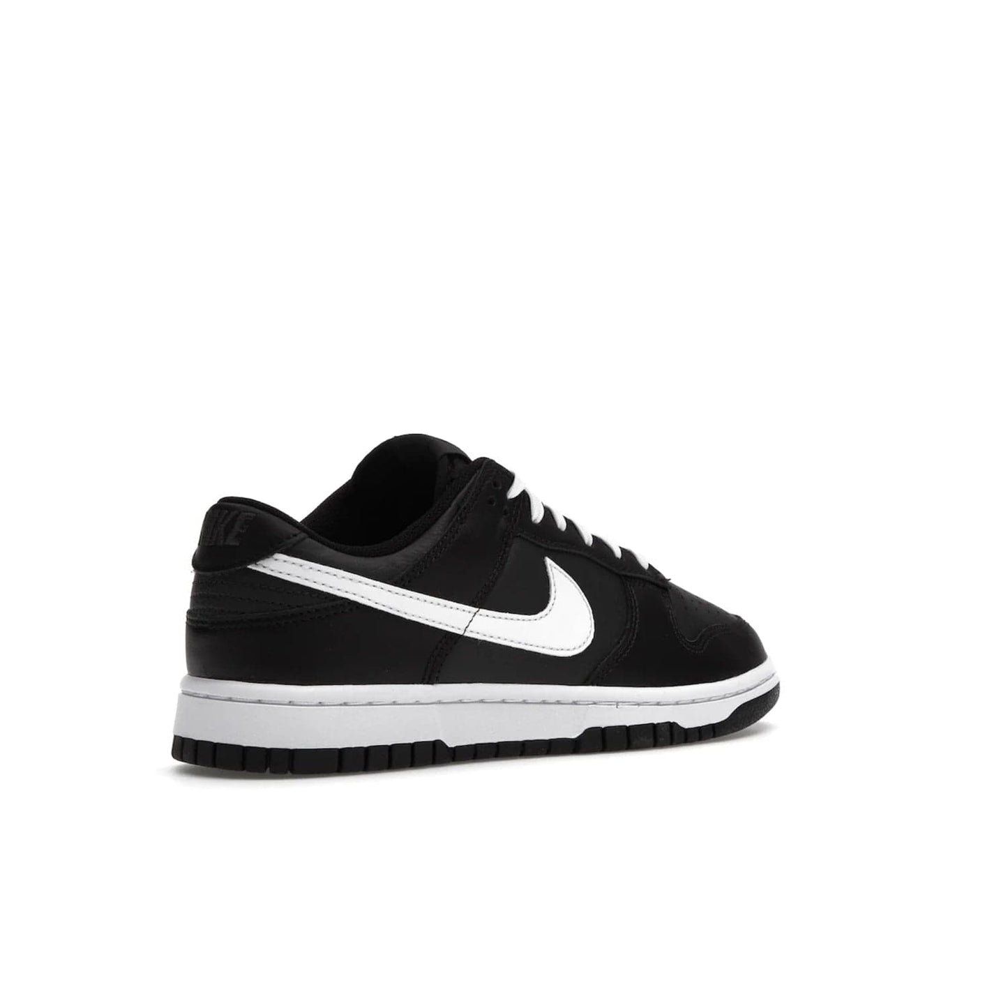Nike Dunk Low Black White (2022) - Image 33 - Only at www.BallersClubKickz.com - A classic Nike Dunk Low in black and white. Its tumbled leather upper features leather overlays and white Nike Swooshes. The design also includes a woven tongue label and an EVA foam sole for cushioning and support. An effortlessly stylish and timeless look. The Nike Dunk Low Black White (2022) released in May. Step out in style.