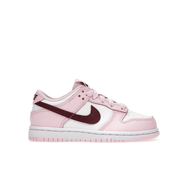Nike Dunk Low Pink Red White (PS) - Image 1 - Only at www.BallersClubKickz.com - Introducing the Nike Dunk Low Pink Red White (PS), the perfect addition to your sneaker collection. A classic silhouette with modern vibrant colors, including a pink upper with red and white accents and a white midsole. Comfort and durability, perfect for any outfit. Limited edition, available June 22nd.