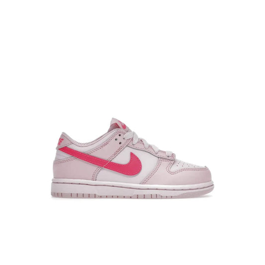 Nike Dunk Low Triple Pink (PS) - Image 1 - Only at www.BallersClubKickz.com - A stunning shoe option for completing any look: Nike Dunk Low Triple Pink (Preschool). Light pink layered leather upper with darker pink synthetic accents. Plus toe box of perforated pink leather and Nike symbol embroidered pull tab. Rubber midsole and outsole. Affordable price of $85.