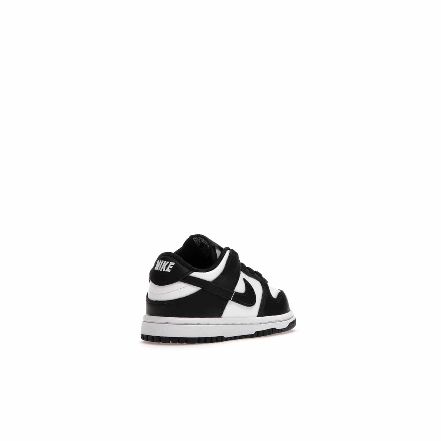 Nike Dunk Low Retro White Black Panda (2021) (TD) - Image 32 - Only at www.BallersClubKickz.com - The perfect blend of classic style and modern style, the Nike Dunk Low Retro White Black (TD) toddler shoe has a soft leather upper, white midsole, and black outsole. Signature Swoosh branding and lightly padded tongue give it timeless Nike style. Released in March 2021.