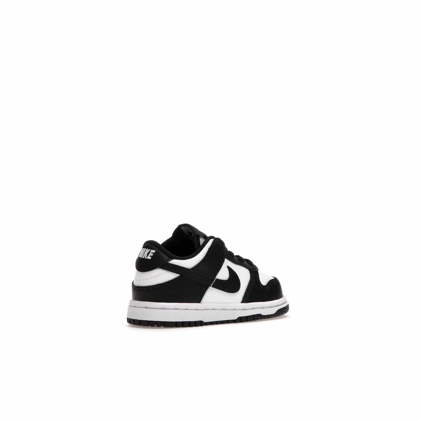 Nike Dunk Low Retro White Black Panda (2021) (TD) - Image 33 - Only at www.BallersClubKickz.com - The perfect blend of classic style and modern style, the Nike Dunk Low Retro White Black (TD) toddler shoe has a soft leather upper, white midsole, and black outsole. Signature Swoosh branding and lightly padded tongue give it timeless Nike style. Released in March 2021.