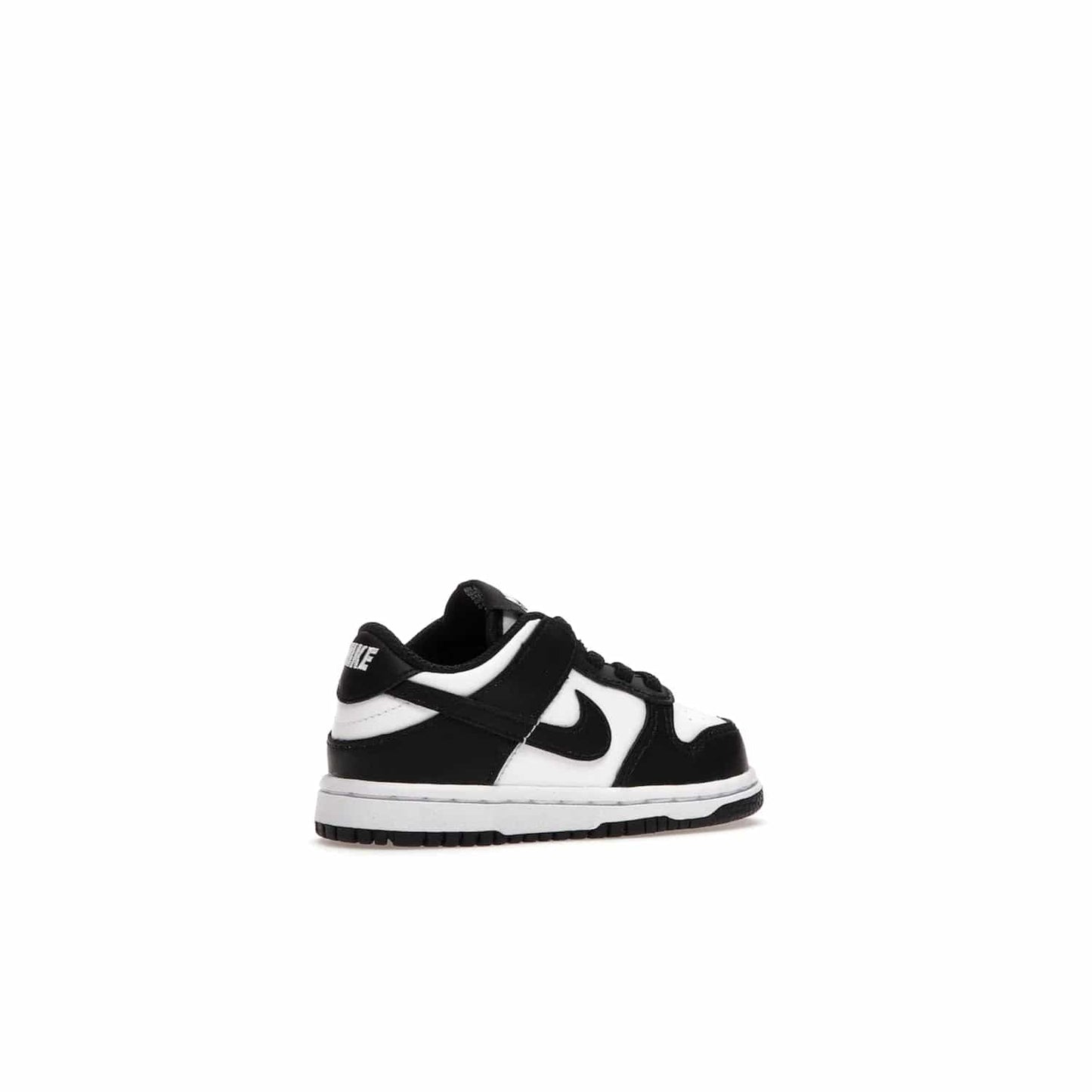Nike Dunk Low Retro White Black Panda (2021) (TD) - Image 34 - Only at www.BallersClubKickz.com - The perfect blend of classic style and modern style, the Nike Dunk Low Retro White Black (TD) toddler shoe has a soft leather upper, white midsole, and black outsole. Signature Swoosh branding and lightly padded tongue give it timeless Nike style. Released in March 2021.