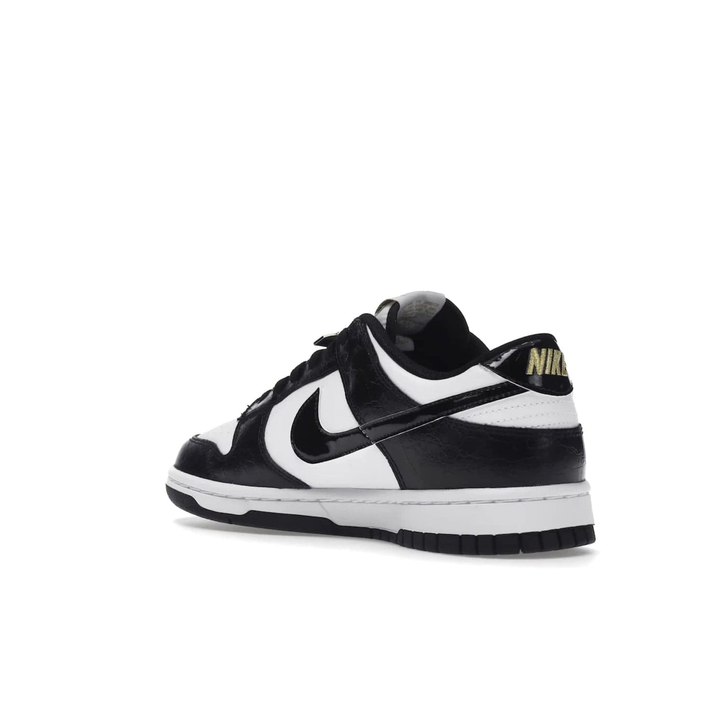 Nike Dunk Low SE World Champs Black White - Image 24 - Only at www.BallersClubKickz.com - Step up your look with the Nike Dunk Low SE World Champs Black White. Leather base, lace eyelets, Swoosh design, gold-stitched brand, and black and gold lace dubraes. Get it in May 2022 for $120.