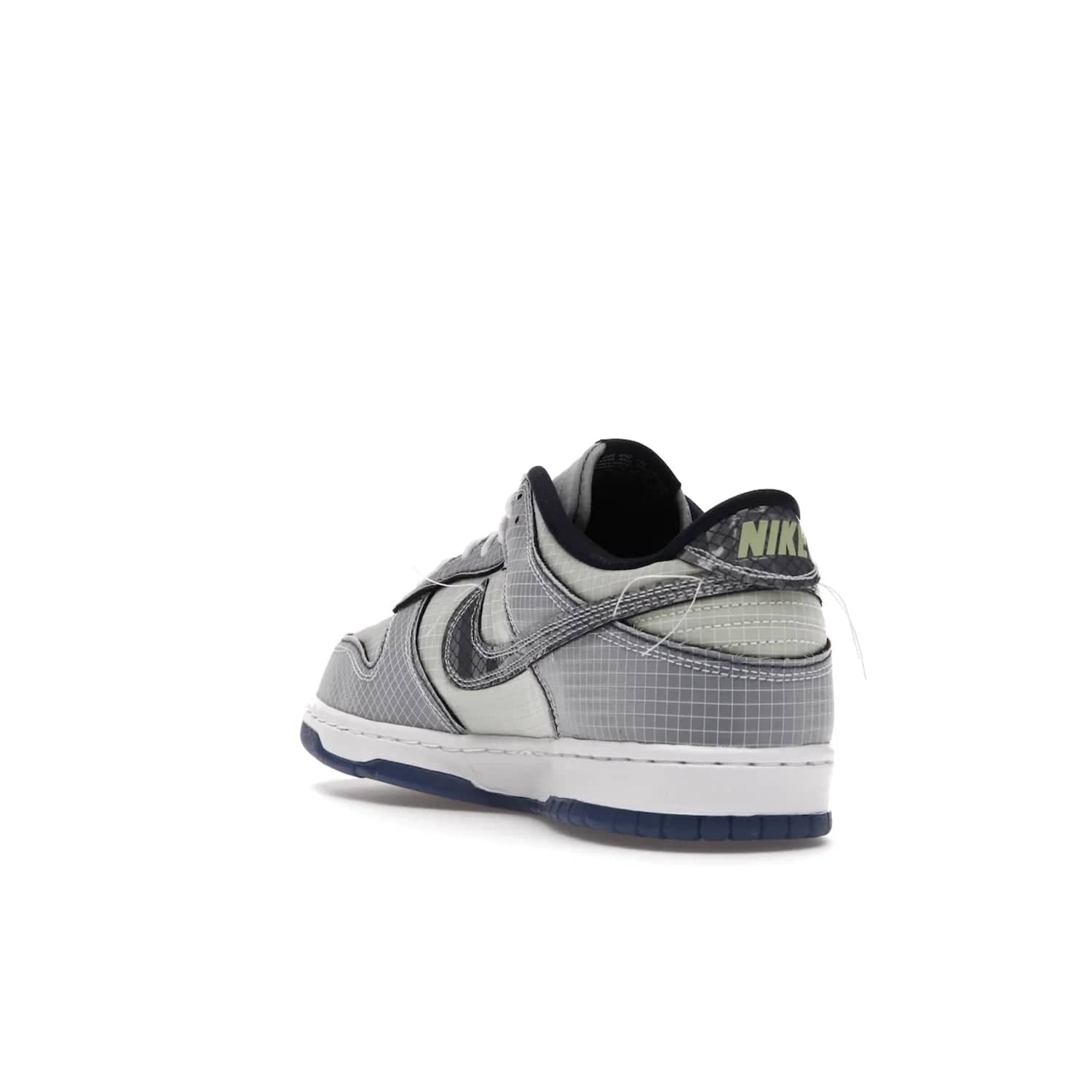 Nike Dunk Low Union Passport Pack Pistachio - Image 25 - Only at www.BallersClubKickz.com - Shop the Nike Dunk Low Union Passport Pack Pistachio! This statement-making silhouette combines light green and navy leather with a semi-translucent ripstop nylon. Comes with exclusive Walter Lee Young-inspired emblem at the heel and a yellow Union LA tab on the quarter panel. Releasing February 2022.