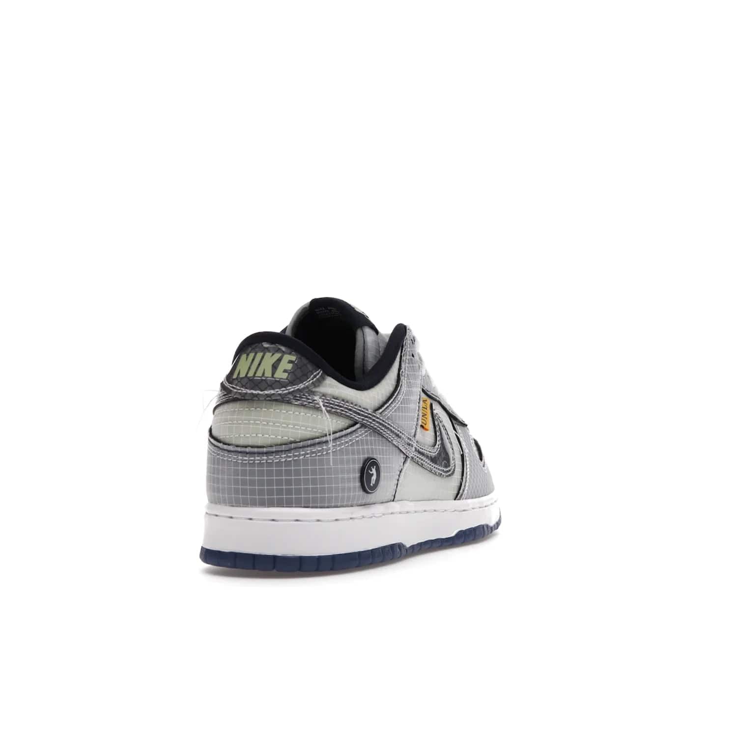 Nike Dunk Low Union Passport Pack Pistachio - Image 30 - Only at www.BallersClubKickz.com - Shop the Nike Dunk Low Union Passport Pack Pistachio! This statement-making silhouette combines light green and navy leather with a semi-translucent ripstop nylon. Comes with exclusive Walter Lee Young-inspired emblem at the heel and a yellow Union LA tab on the quarter panel. Releasing February 2022.