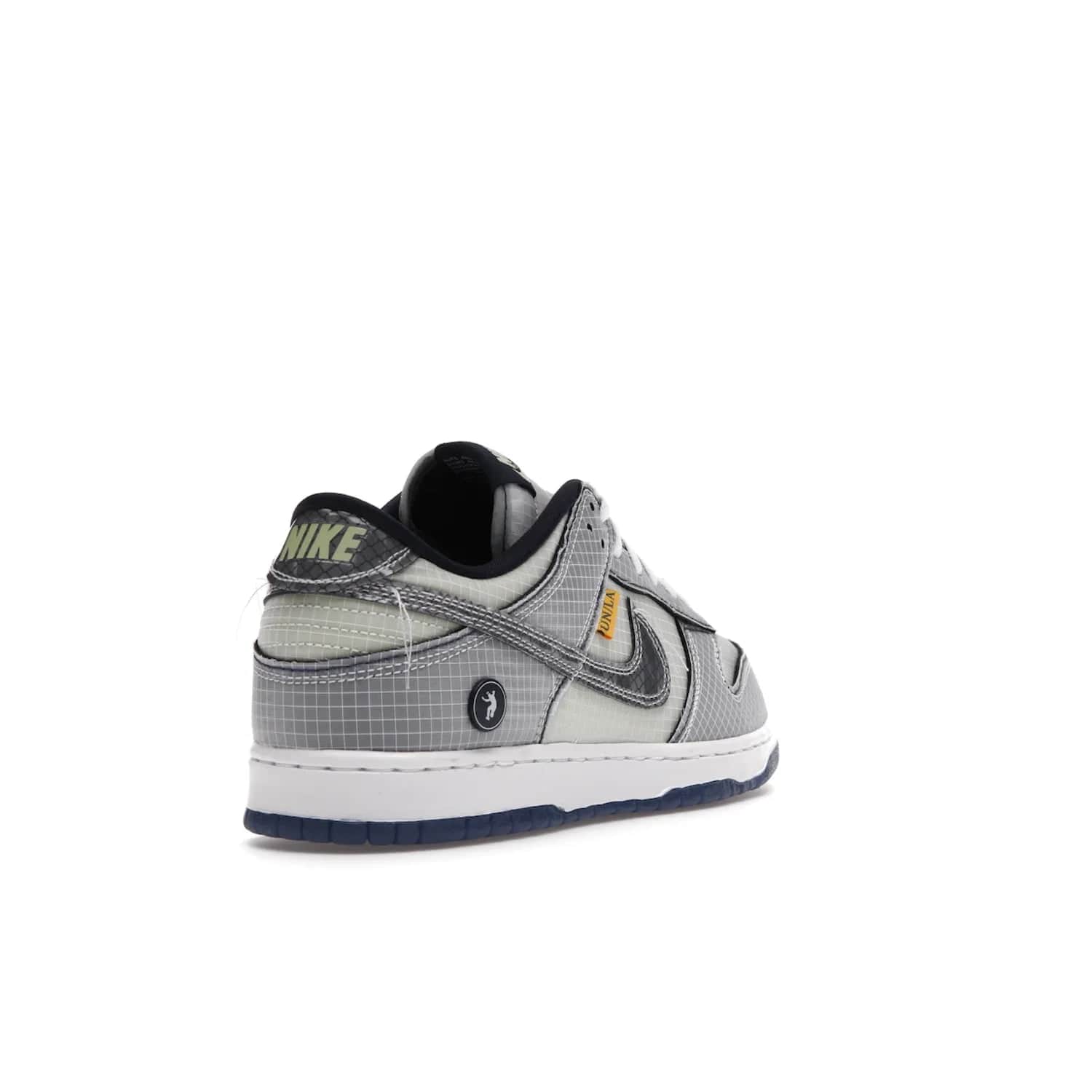 Nike Dunk Low Union Passport Pack Pistachio - Image 31 - Only at www.BallersClubKickz.com - Shop the Nike Dunk Low Union Passport Pack Pistachio! This statement-making silhouette combines light green and navy leather with a semi-translucent ripstop nylon. Comes with exclusive Walter Lee Young-inspired emblem at the heel and a yellow Union LA tab on the quarter panel. Releasing February 2022.