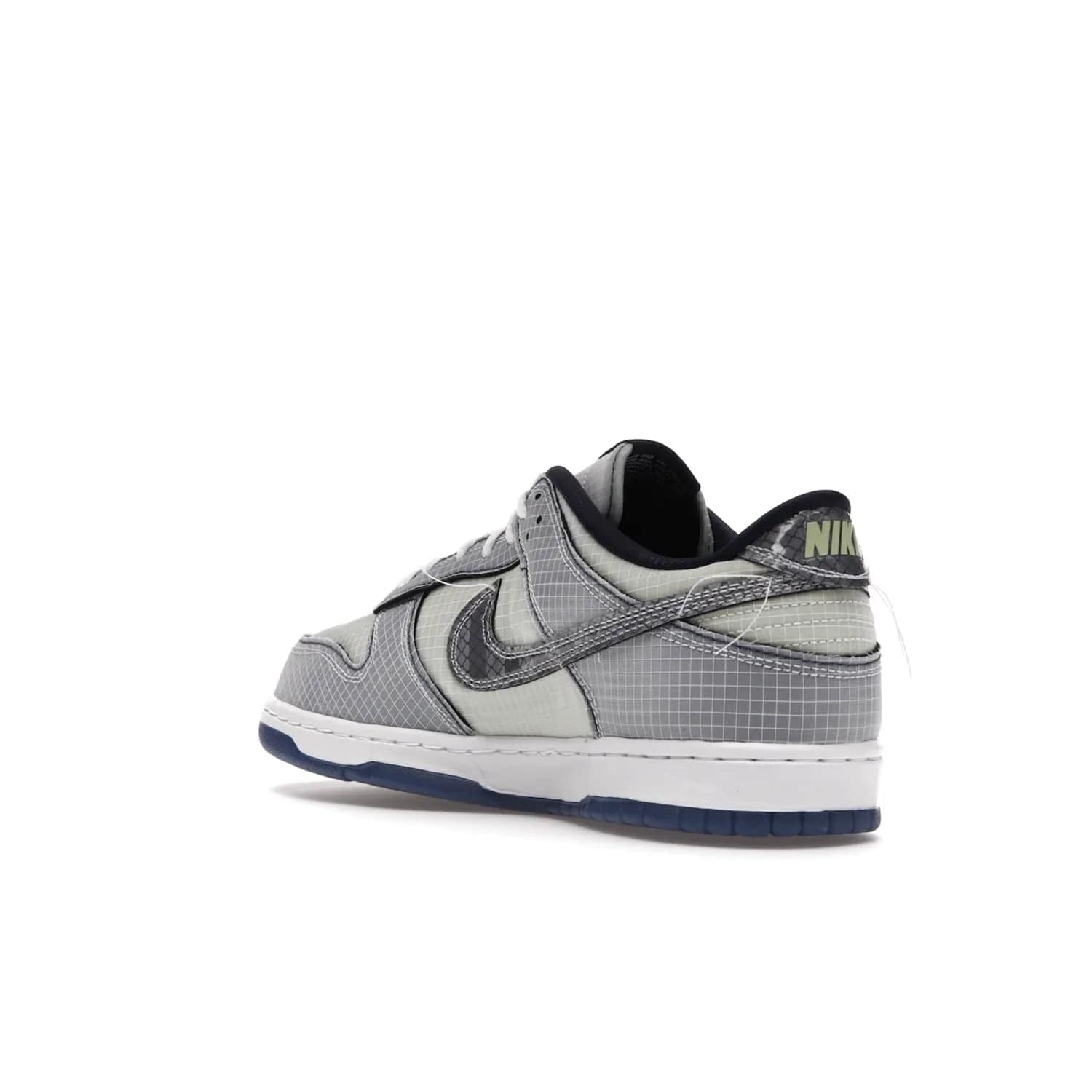 Nike Dunk Low Union Passport Pack Pistachio - Image 24 - Only at www.BallersClubKickz.com - Shop the Nike Dunk Low Union Passport Pack Pistachio! This statement-making silhouette combines light green and navy leather with a semi-translucent ripstop nylon. Comes with exclusive Walter Lee Young-inspired emblem at the heel and a yellow Union LA tab on the quarter panel. Releasing February 2022.