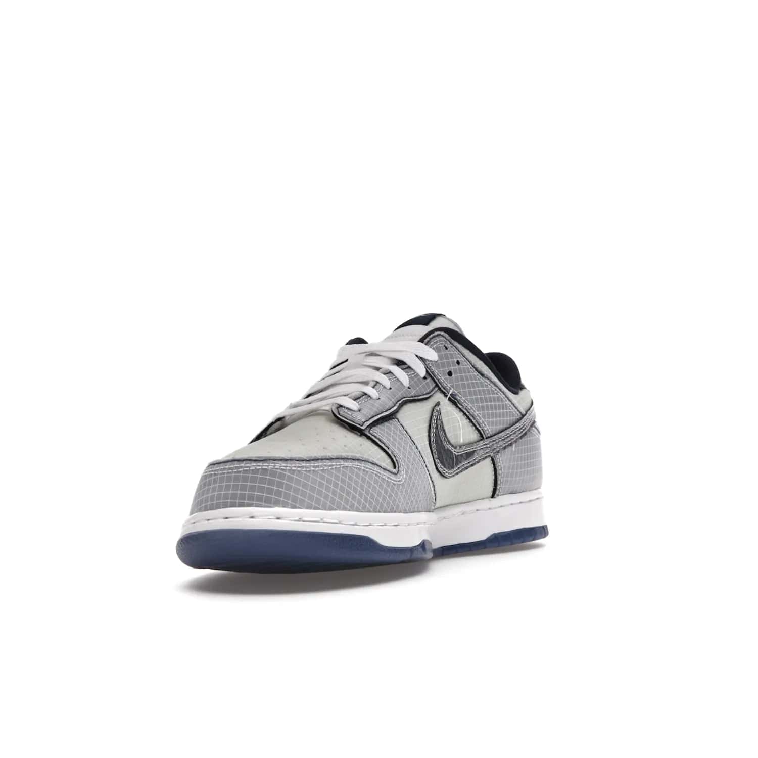 Nike Dunk Low Union Passport Pack Pistachio - Image 13 - Only at www.BallersClubKickz.com - Shop the Nike Dunk Low Union Passport Pack Pistachio! This statement-making silhouette combines light green and navy leather with a semi-translucent ripstop nylon. Comes with exclusive Walter Lee Young-inspired emblem at the heel and a yellow Union LA tab on the quarter panel. Releasing February 2022.