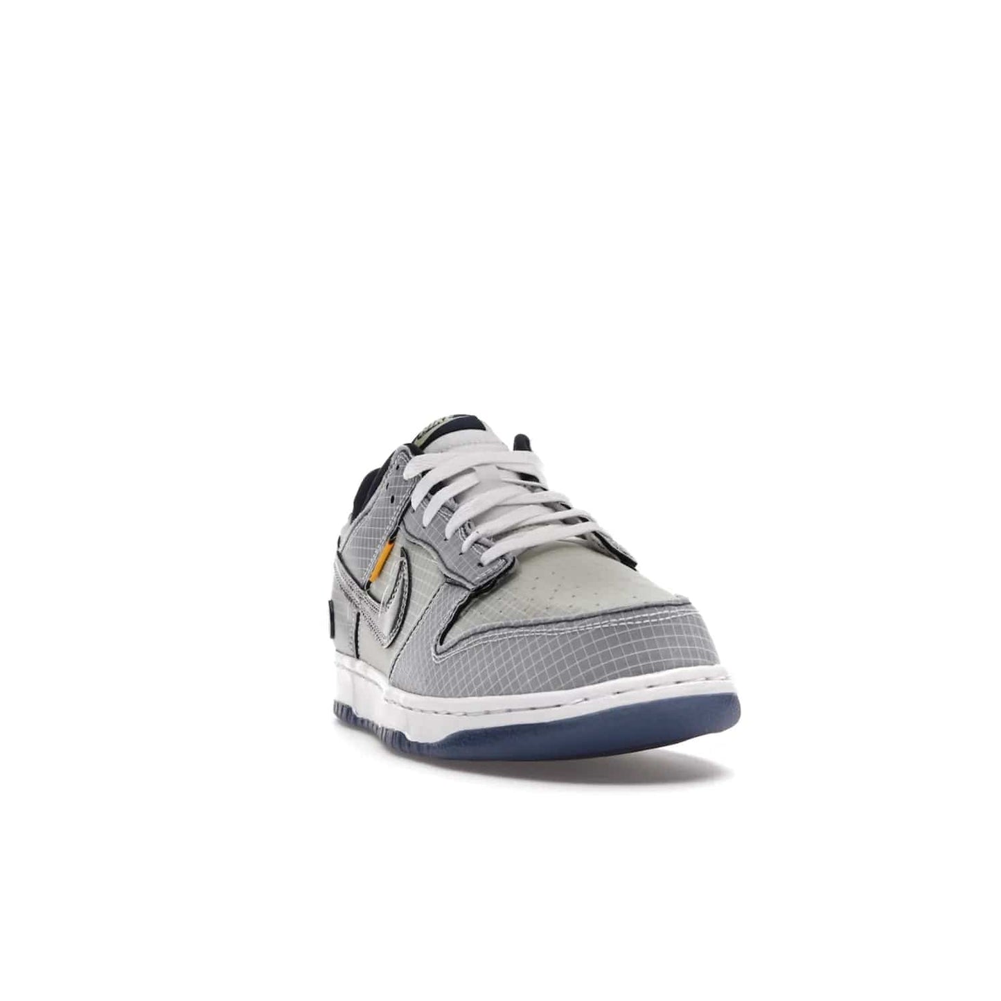 Nike Dunk Low Union Passport Pack Pistachio - Image 8 - Only at www.BallersClubKickz.com - Shop the Nike Dunk Low Union Passport Pack Pistachio! This statement-making silhouette combines light green and navy leather with a semi-translucent ripstop nylon. Comes with exclusive Walter Lee Young-inspired emblem at the heel and a yellow Union LA tab on the quarter panel. Releasing February 2022.