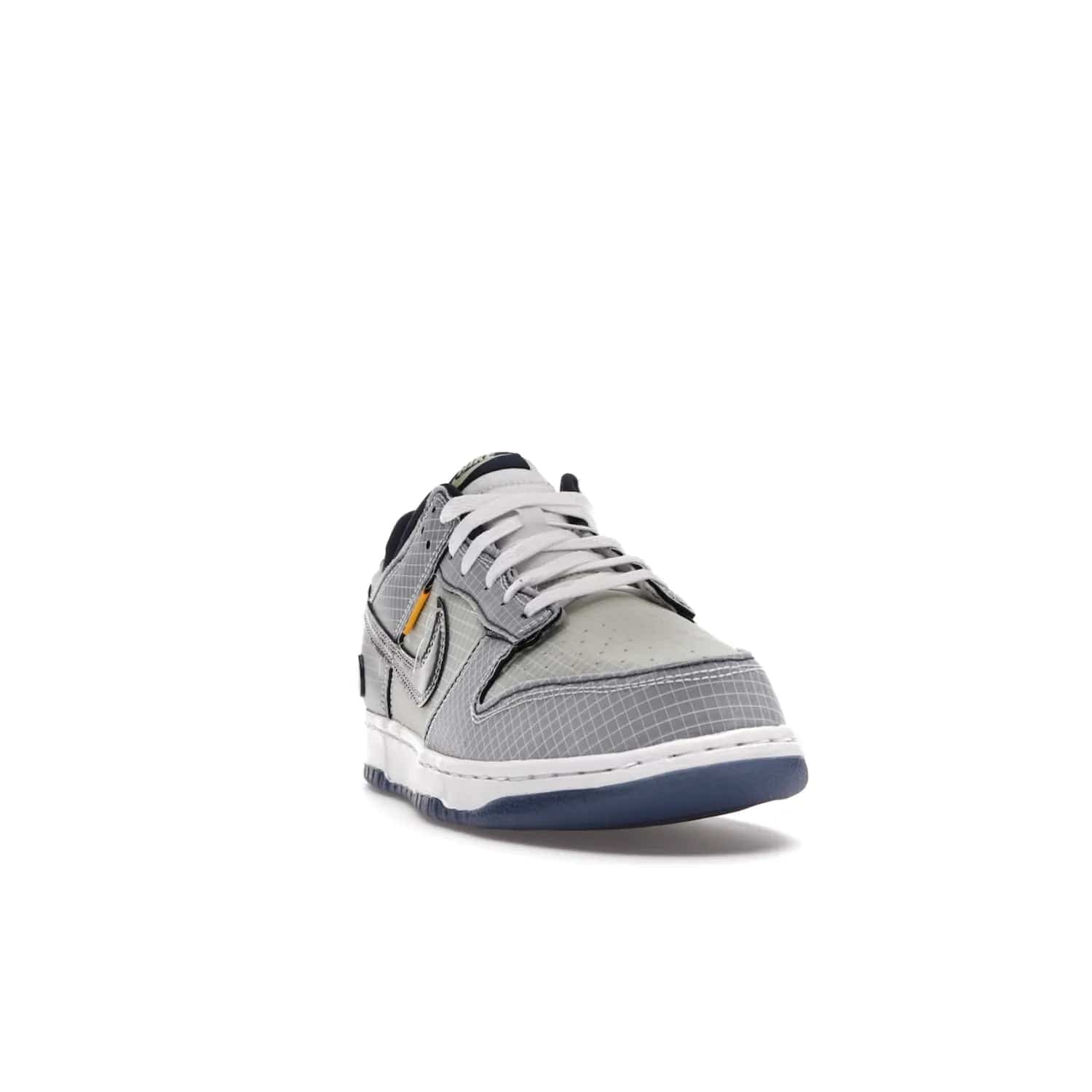 Nike Dunk Low Union Passport Pack Pistachio - Image 8 - Only at www.BallersClubKickz.com - Shop the Nike Dunk Low Union Passport Pack Pistachio! This statement-making silhouette combines light green and navy leather with a semi-translucent ripstop nylon. Comes with exclusive Walter Lee Young-inspired emblem at the heel and a yellow Union LA tab on the quarter panel. Releasing February 2022.