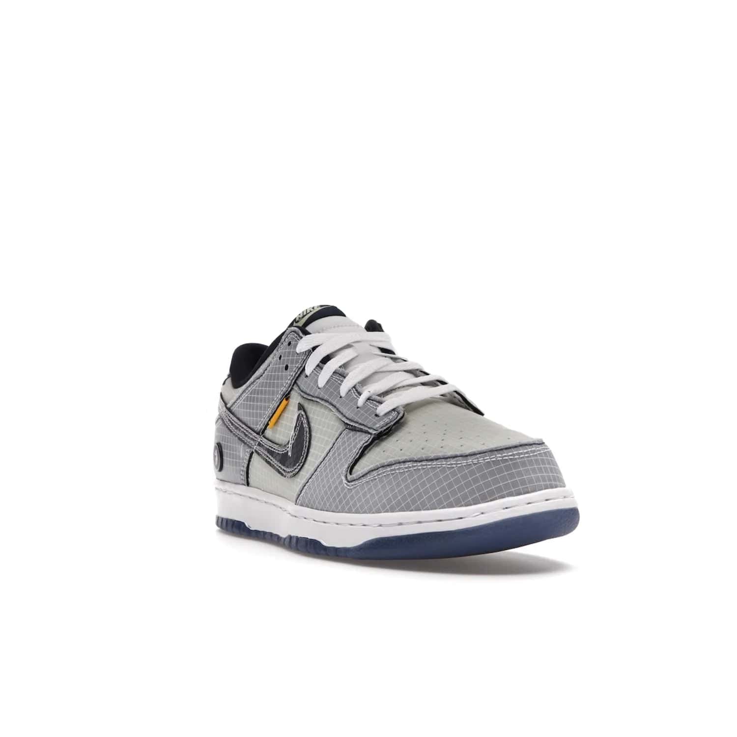 Nike Dunk Low Union Passport Pack Pistachio - Image 7 - Only at www.BallersClubKickz.com - Shop the Nike Dunk Low Union Passport Pack Pistachio! This statement-making silhouette combines light green and navy leather with a semi-translucent ripstop nylon. Comes with exclusive Walter Lee Young-inspired emblem at the heel and a yellow Union LA tab on the quarter panel. Releasing February 2022.