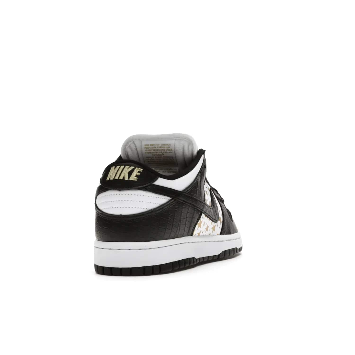 Nike SB Dunk Low Supreme Stars Black (2021) - Image 30 - Only at www.BallersClubKickz.com - Retro style and signature details make the Nike SB Dunk Low Supreme Black a must-have. This special edition shoe features a white leather upper and black croc skin overlays complemented by gold stars and deubré. Enjoy a piece of SB history and grab yours today.