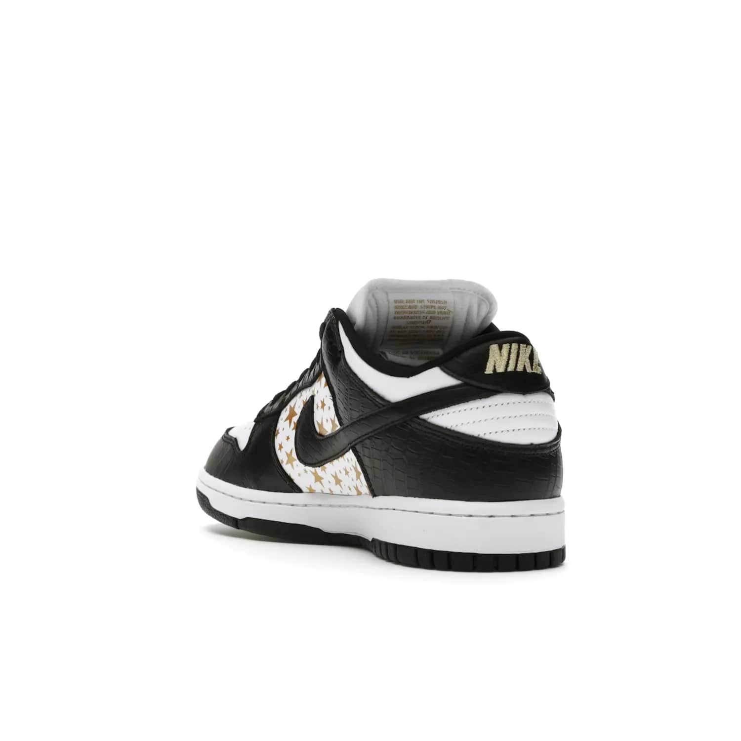 Nike SB Dunk Low Supreme Stars Black (2021) - Image 25 - Only at www.BallersClubKickz.com - Retro style and signature details make the Nike SB Dunk Low Supreme Black a must-have. This special edition shoe features a white leather upper and black croc skin overlays complemented by gold stars and deubré. Enjoy a piece of SB history and grab yours today.