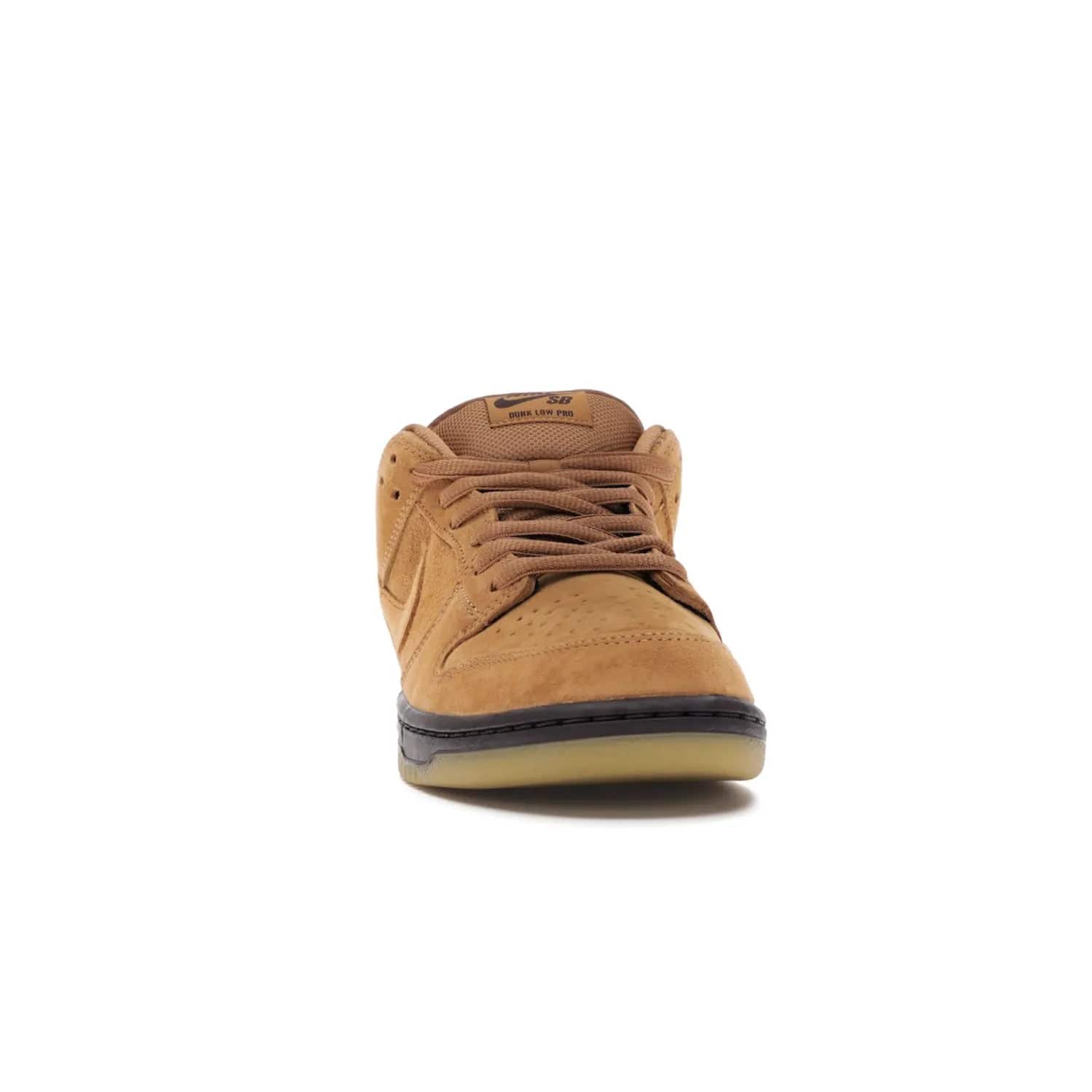 Nike SB Dunk Low Wheat (2021/2023) - Image 9 - Only at www.BallersClubKickz.com - The Nike SB Dunk Low Wheat (2021/2023)has a sleek silhouette and wheat suede upper. Tan tones for lining, mesh tongues, and laces. Iconic color palette midsole, perforated boxing toe. Brown branding on tongue and heel. Gum rubber outsole with partitioned pattern for traction. Eschewed in Feb 2021 for $110.