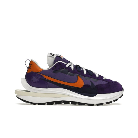 Nike Vaporwaffle sacai Dark Iris - Image 1 - Only at www.BallersClubKickz.com - Unique Nike Vaporwaffle sacai Dark Iris collab. Suede, leather & textile upper with Orange accents. Dual tongues & midsoles. Woven labels & heel tabs branding. Colorway of Purple, Orange, White & Black. Must-have for any wardrobe.