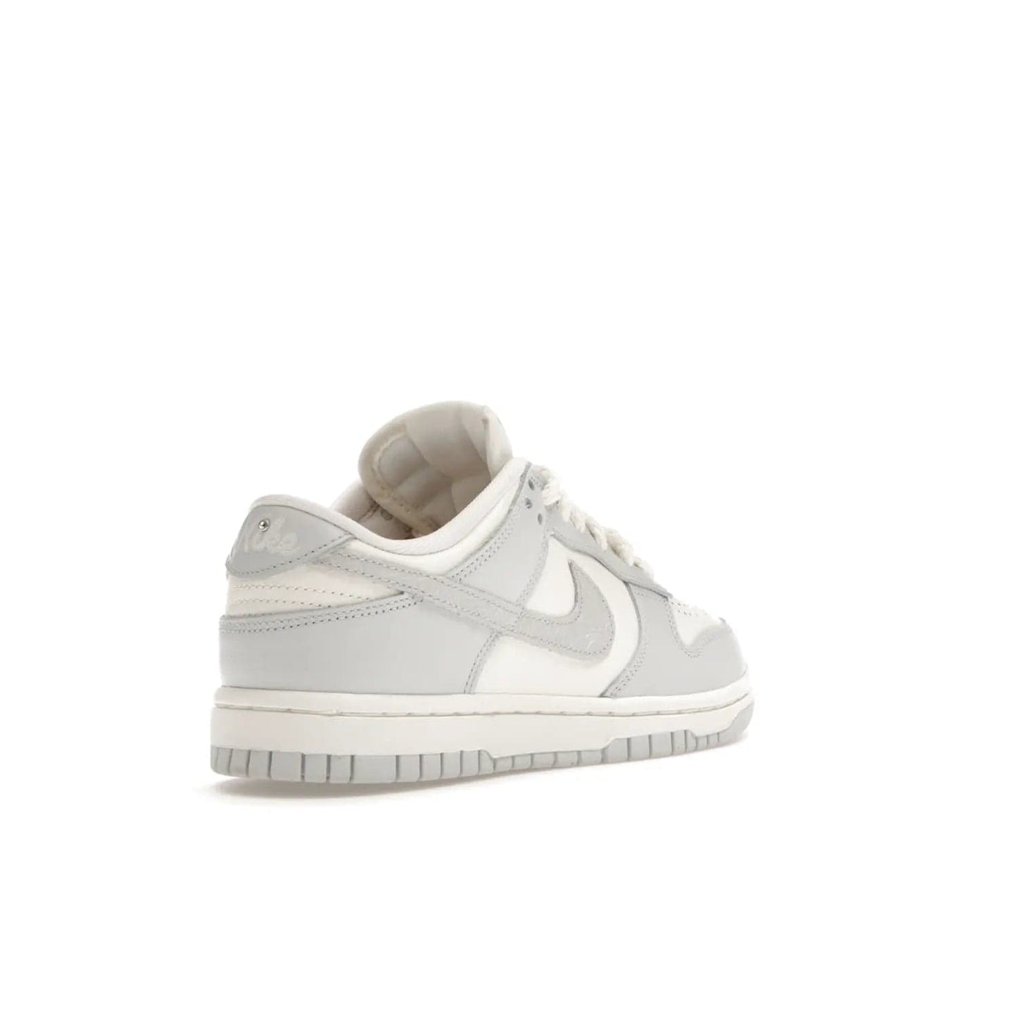Nike Dunk Low Needlework Sail Aura (Women's) - Image 32 - Only at www.BallersClubKickz.com - Discover the Nike Dunk Low Needlework Sail Aura for Women. Boasting a beautiful Sail and Neutral Grey upper, this stylish sneaker offers durable materials with ultra-soft cushioning for all-day comfort. Get your pair today!