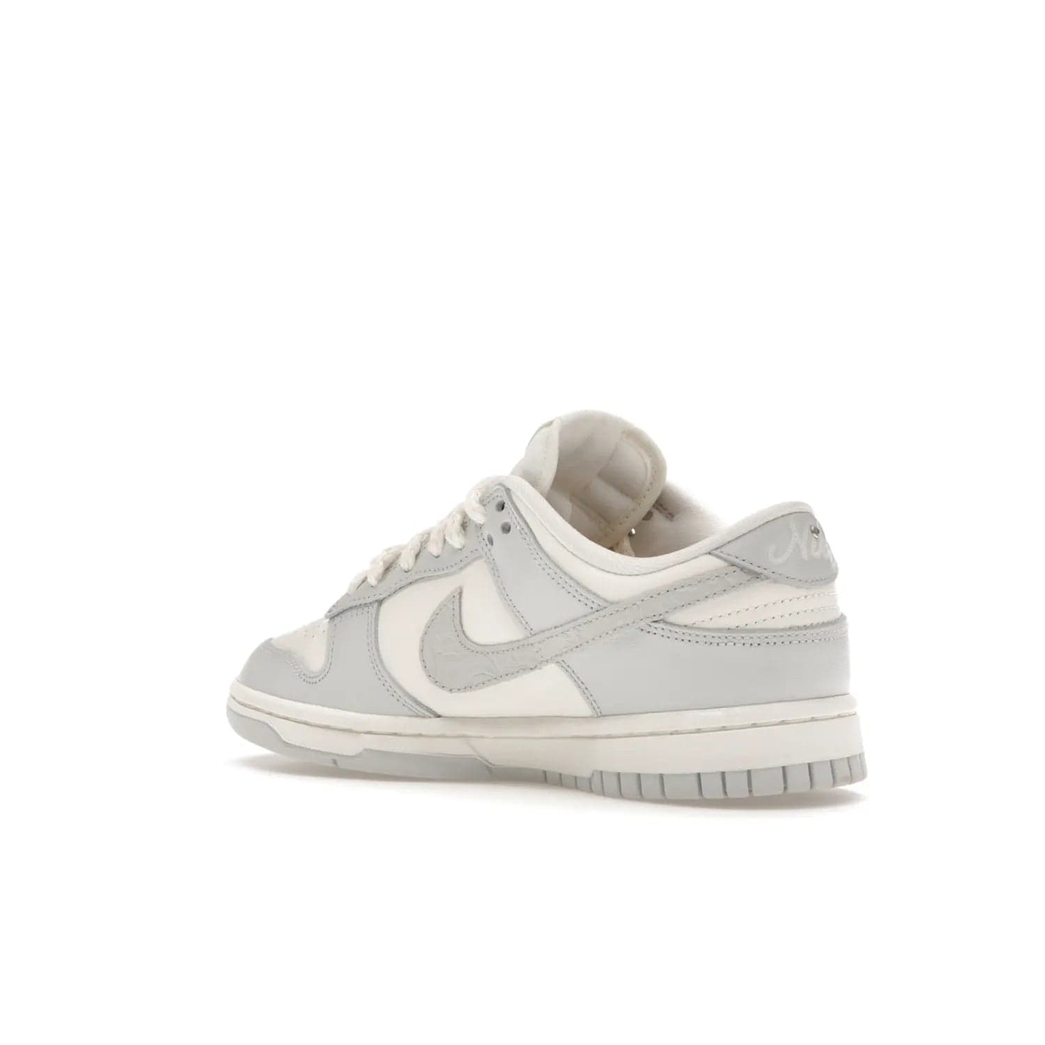 Nike Dunk Low Needlework Sail Aura (Women's) - Image 23 - Only at www.BallersClubKickz.com - Discover the Nike Dunk Low Needlework Sail Aura for Women. Boasting a beautiful Sail and Neutral Grey upper, this stylish sneaker offers durable materials with ultra-soft cushioning for all-day comfort. Get your pair today!