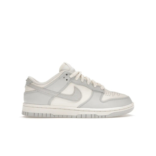 Nike Dunk Low Needlework Sail Aura (Women's) - Image 1 - Only at www.BallersClubKickz.com - Discover the Nike Dunk Low Needlework Sail Aura for Women. Boasting a beautiful Sail and Neutral Grey upper, this stylish sneaker offers durable materials with ultra-soft cushioning for all-day comfort. Get your pair today!