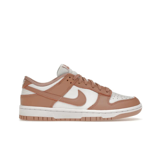 Nike Dunk Low Rose Whisper (Women's) - Image 1 - Only at www.BallersClubKickz.com - The Nike Dunk Low Rose Whisper is the perfect summer shoe with classic two-tone look and vintage-inspired design. Features white and Rose Whisper leather upper, woven tongue labels and EVA foam sole for plush cushioning. Available June 2022 at $100.